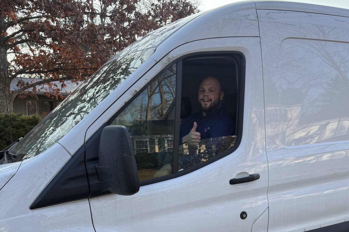 Ian Montgomery, owner of Commodore Heating and Cooling, in a service van in Toledo, Ohio