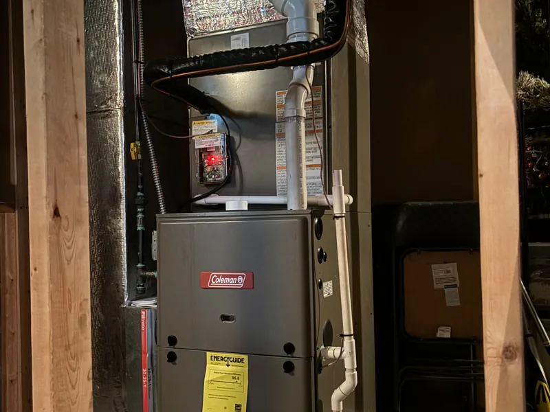 Newly installed high-efficiency Coleman gas furnace with PVC venting in a Toledo home basement